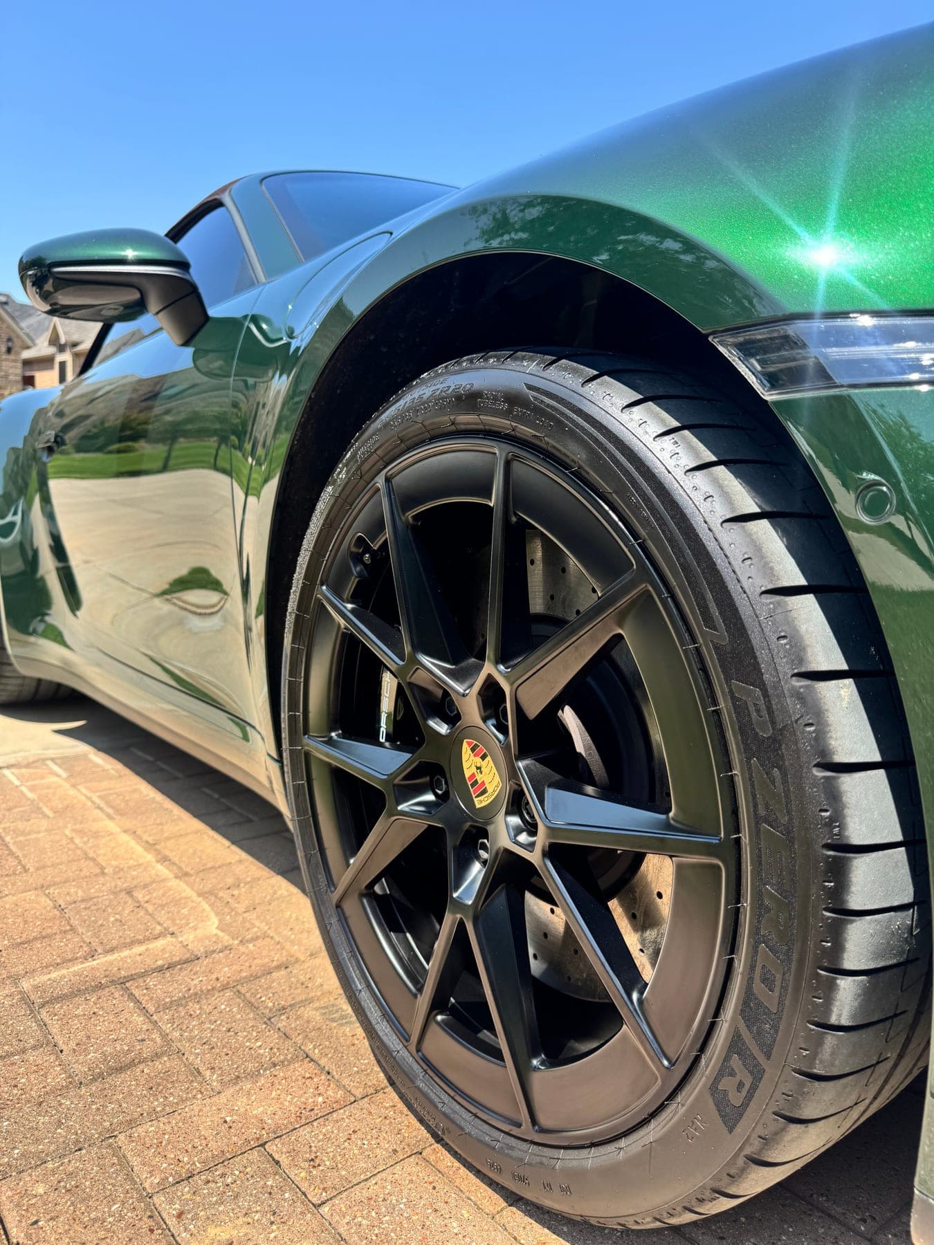 Close-up of a green Porsche's wheel and barrel after detailing